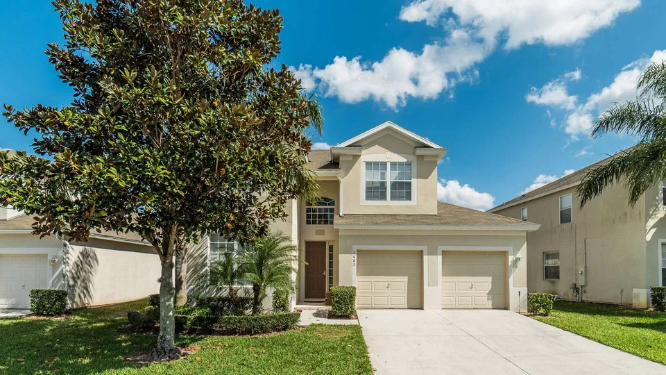 Two-story house with garage and trees