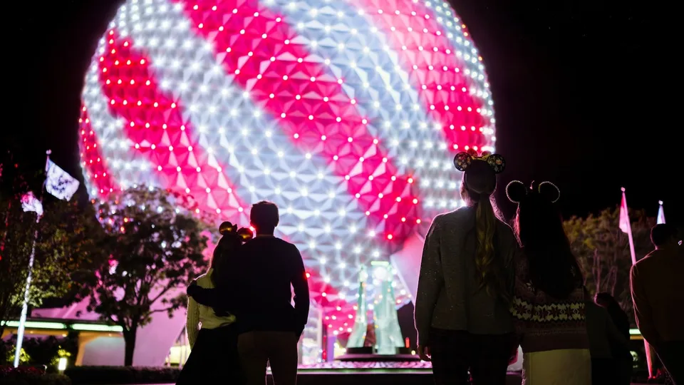 EPCOT's illuminated Spaceship Earth with holiday decorations