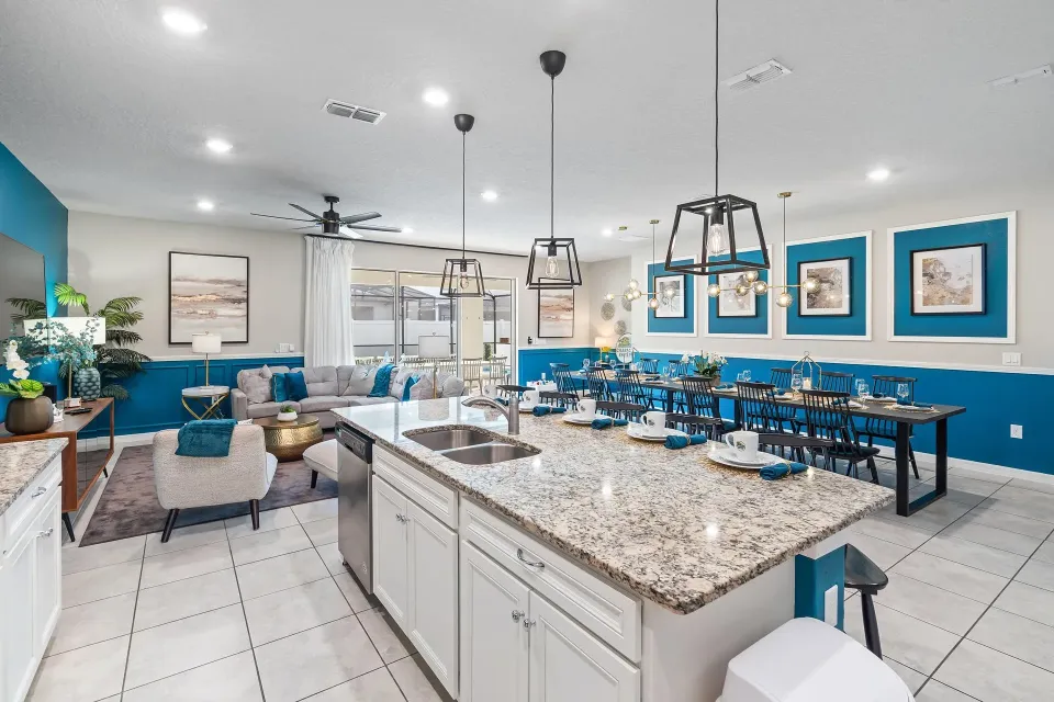 The image depicts an elegant dining area featuring a large table, ideal for group meals and celebrations, surrounded by stylish decor that enhances the luxurious atmosphere. This space is perfect for families and friends to gather and create lasting memories during their vacation at an Orlando villa, complete with all the amenities for a comfortable stay.
