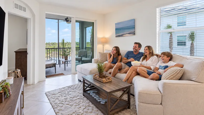 A family enjoying a movie and popcorn in their vacation-home living room