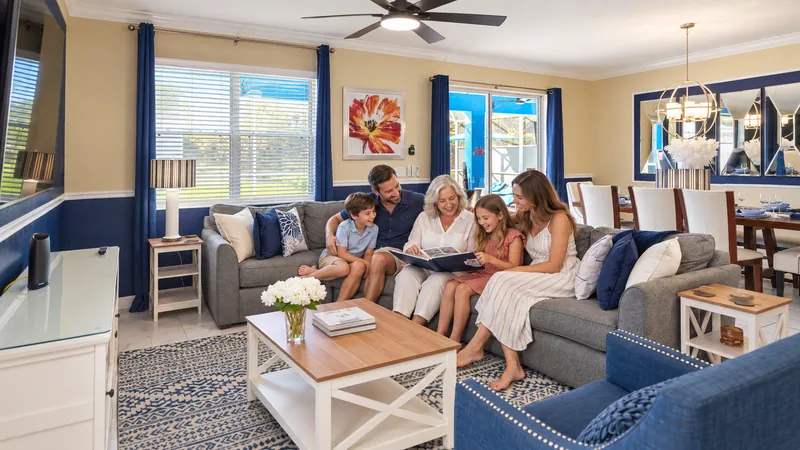 Three generations enjoying a photo album together in their vacation home